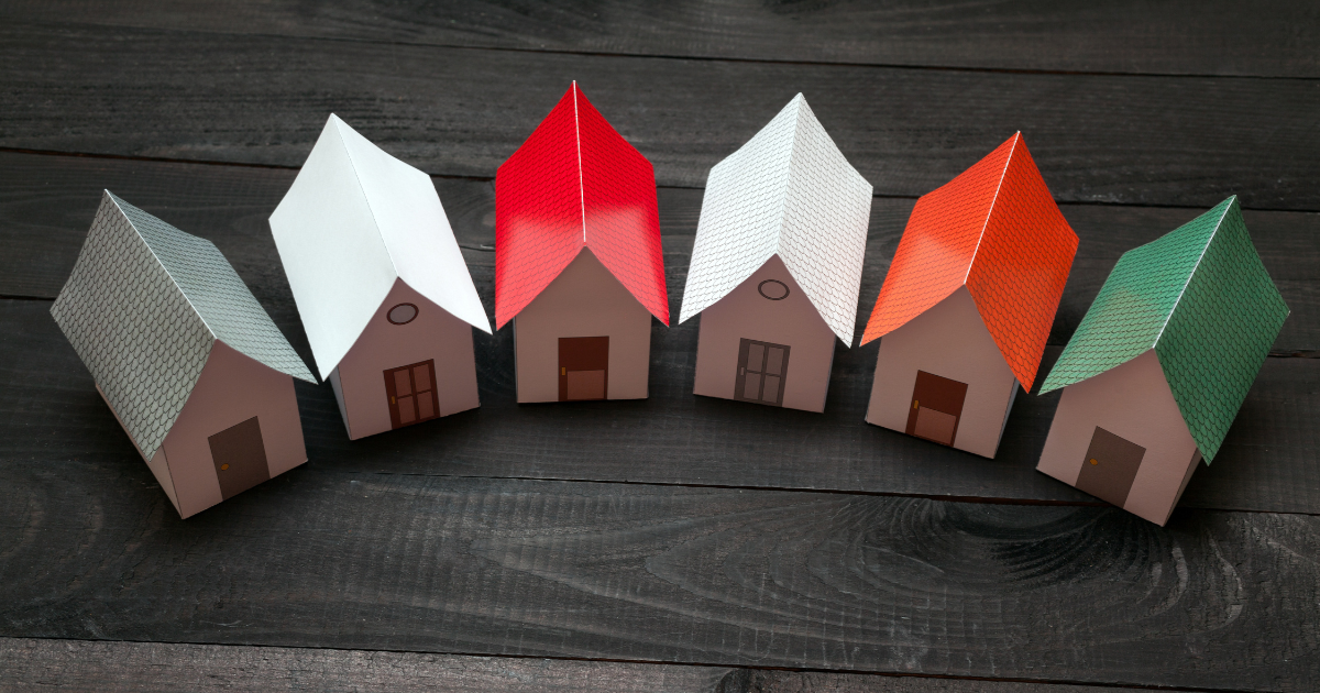 A line of folded paper houses